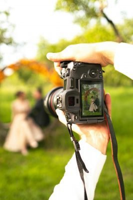 Wedding photographer capturing a candid moment during a wedding ceremony